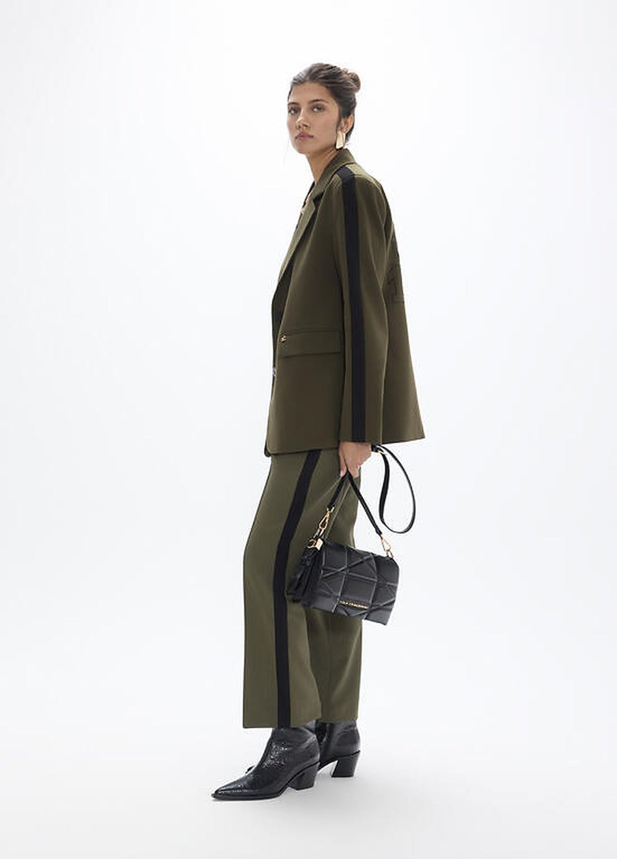 https://cdn.shopify.com/s/files/1/0368/5521/8235/files/olives-restored-aw26-lola-casademunt-trousers-san-sebastian-lf2614026-02.jpg?v=1792433131